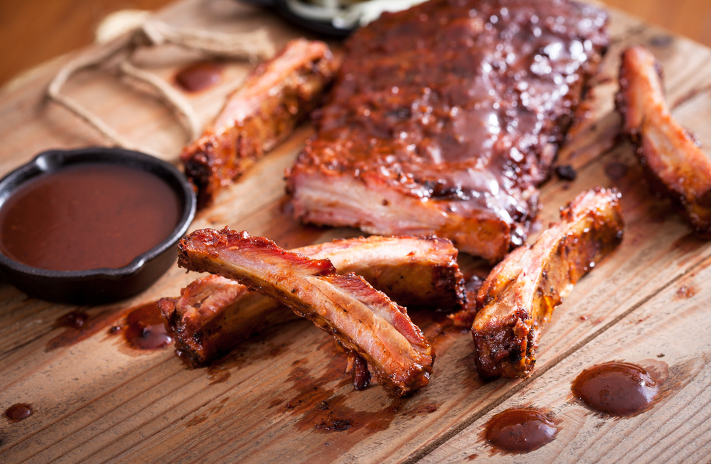 Barbecue ribs served on a rustic wooden board